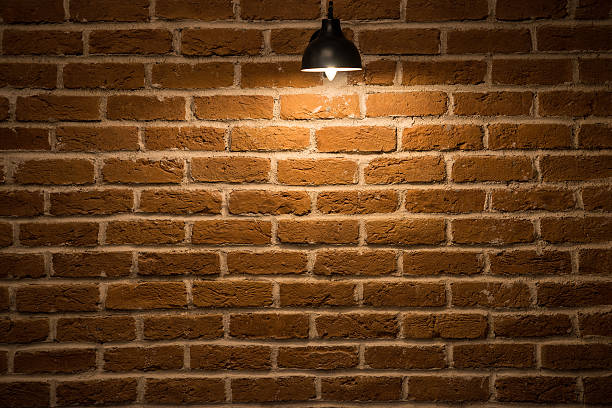istock Pendant Lights Hanging Against Brick Wall 483748336