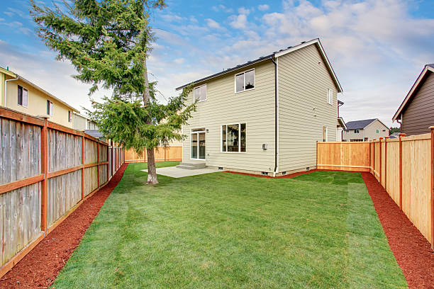 istock Luxury back yard with unfurnished patio and grass. 483748696