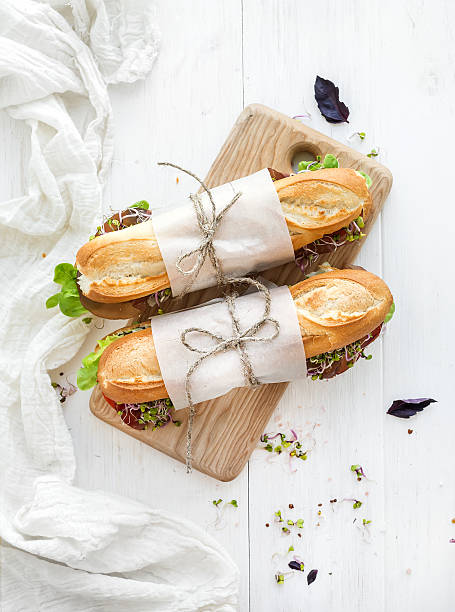 istock Sandwiches with beef, fresh vegetables and herbs on rustic wooden 483749592