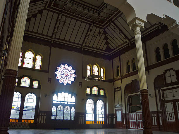 Istanbul, Turkey - March 11, 2013: View of dark three-story main entrance hall of Sirkeci Train station from inside, showing detailed wall- and roof facades, windows and architectural designs.