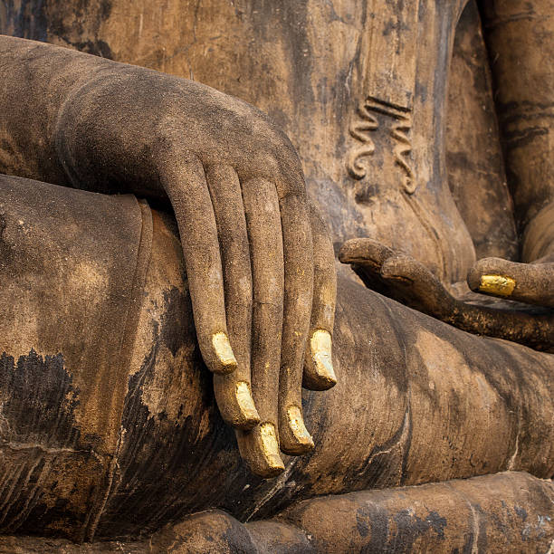 istock Hand of an ancient Buddha statue 483750831
