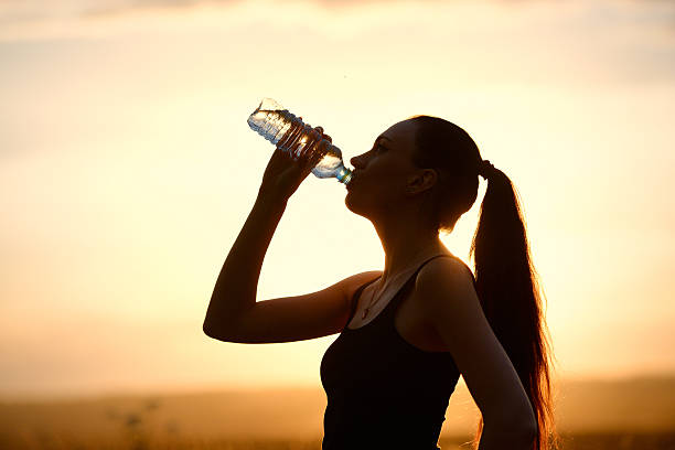 istock Woman silhouette drinking water 483751391