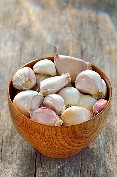 istock garlic in a wooden bowl 483753335