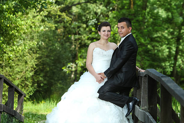 istock Newlyweds on wooden bridge in nature 483756040