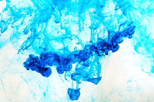 Abstract blue dye in water demonstrating fluid dynamicsAbstract purple dye in water demonstrating fluid dynamics