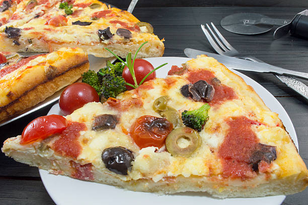 istock Vegetarian pizza slice served with cherry tomato and broccoli 483765994