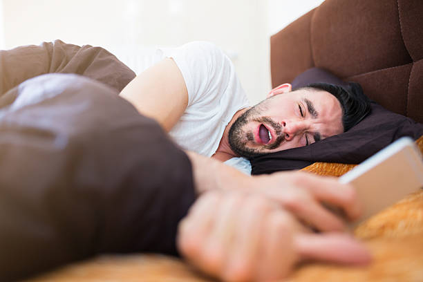 istock Lazy morning in bed with smart phone 483767366