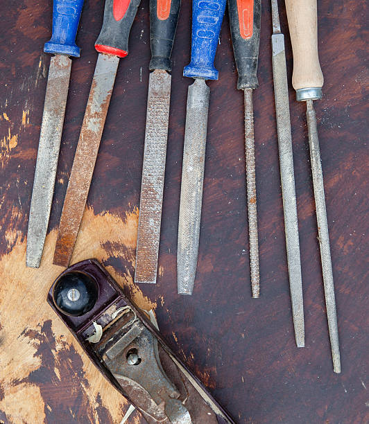 istock Used chisels and a plane on a dark wooden table 483767436