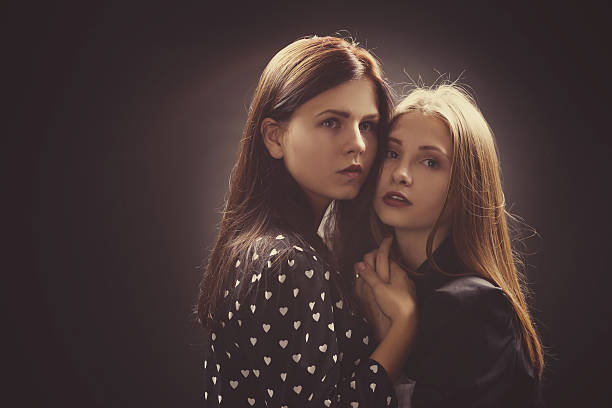 istock girls studio portrait on dark background 483767464