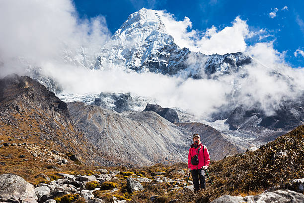 istock Woman backpacker standing in front Ama Dablam mountain peaks. 483768486