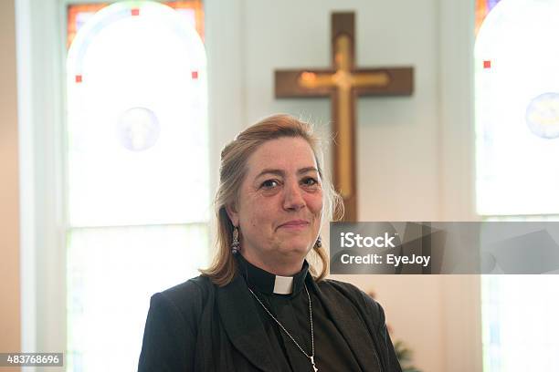 Candid Of Female Minister Inside Church Stock Photo - Download Image Now - Priest, Minister - Clergy, Females