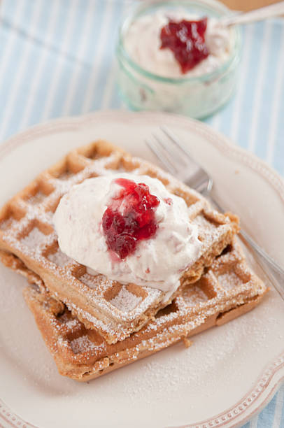 istock Home made waffles with jam and whipped cream 483769339