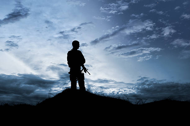 istock Military Soldier Keeps Watch Under a Night Sky 483769789