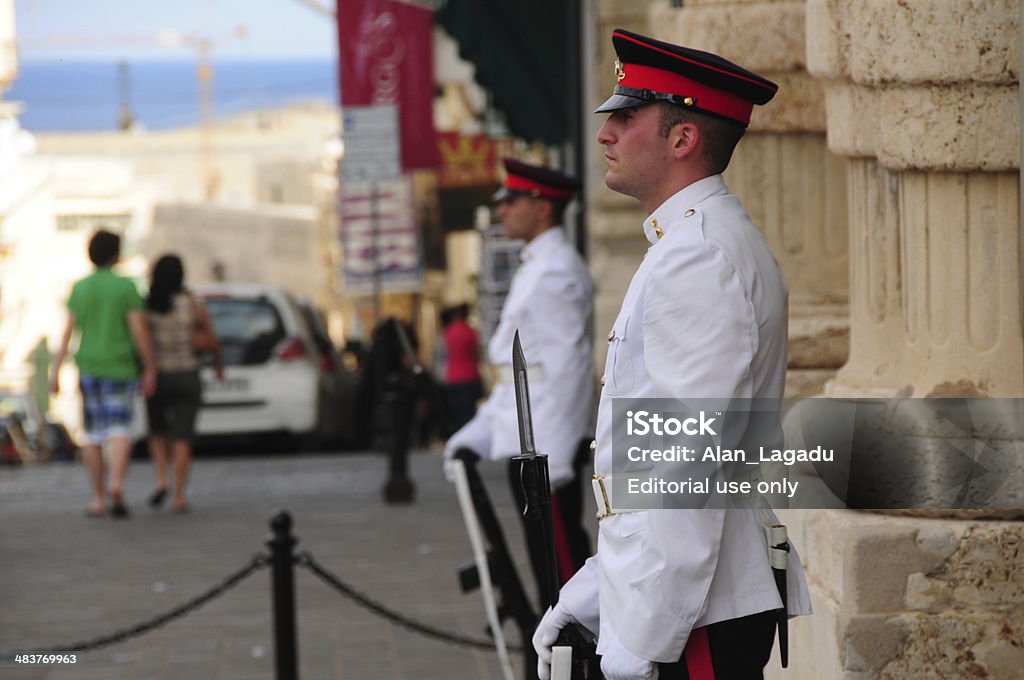 Valletta, Malta. Valletta, Maltese Islands  - October 25, 2013: Armed guards of the Maltese Marines outside the State Armoury of St.George's square with tourists passing by. Adult Stock Photo