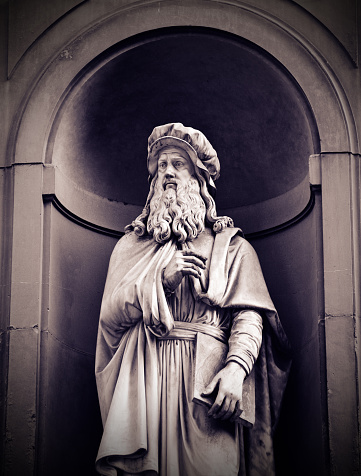 Statue, completed c1839 of Leonardo da Vinci (1452 – 1519), Tuscan polymath of the Italian Renaissance, by Luigi Pampaloni (1791-1847), outside the Uffizi Gallery in central Florence.