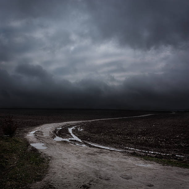Night Landscape with Country Road and Dark Clouds stock photo