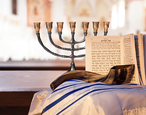 Jewish Menorah, Shofar, prayer book, and Talit Menorah, Shofar, prayer book and prayer shawl for the high holidays of  Rosh Hashana and Yom Kippur religious celebration audio stock pictures, royalty-free photos & images