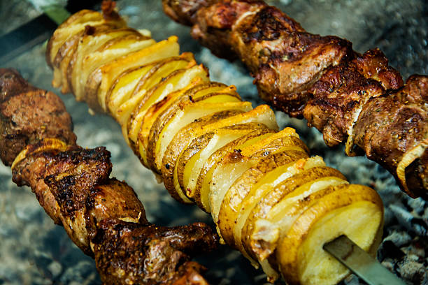 istock Meat and potatoes on skewers, cooked hot coals 483771916