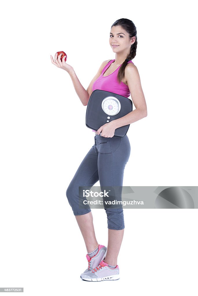 Fitness Woman Healthy diet eating woman with scale and apple for weightloss isolated on white background Achievement Stock Photo