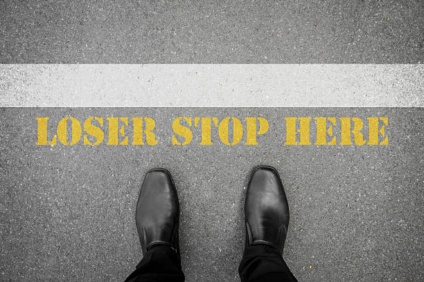 istock Shoes standing at the line loser stop here 483772726