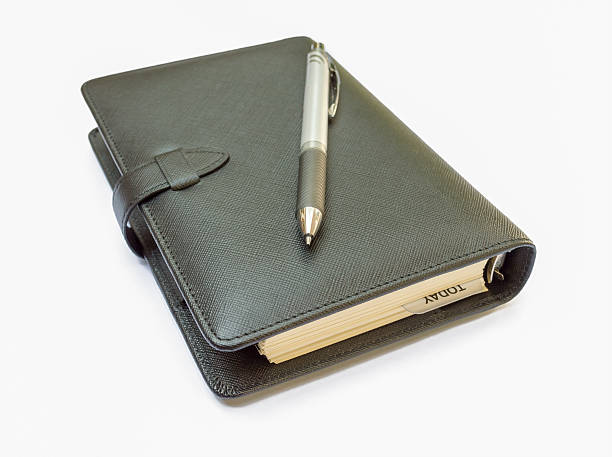 istock Leather notebook and pen in the White background 483772757