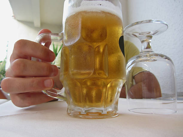 istock Male hand holding a cold mug of light beer 483772850