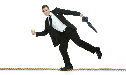 Smiling businessman walking on tightropehttp://www.twodozendesign.info/i/1.png