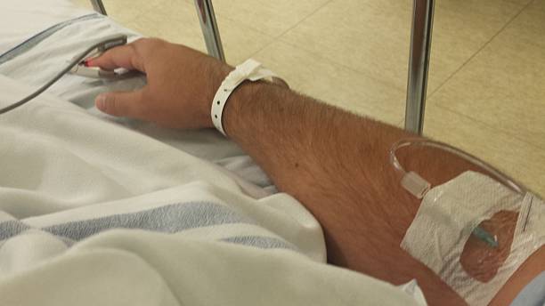 istock Patient arm with intravenous drip and oximeter 483773178