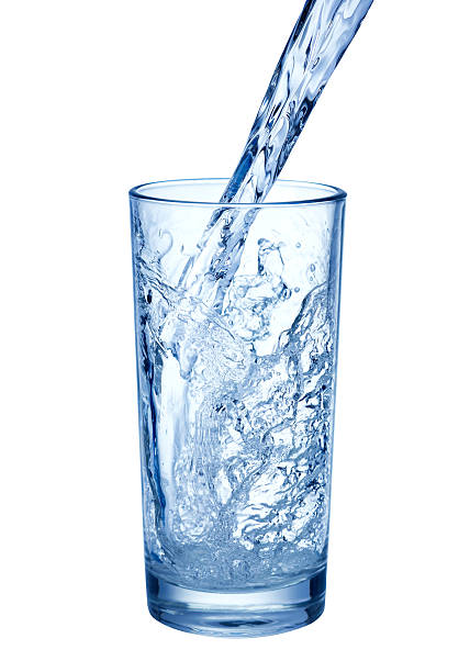 istock pouring water on glass on white background 483773273