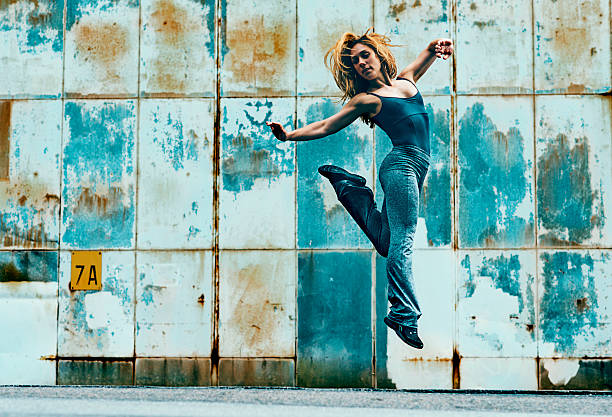 istock Woman jumps high into the air and makes a kick 483774986