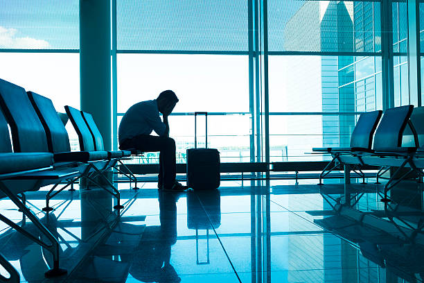 istock Unhappy passenger waits for flight at airport 483775026