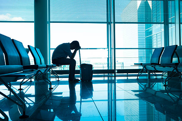 istock Frustrated and tired passenger waits for delayed plane at airport 483775080