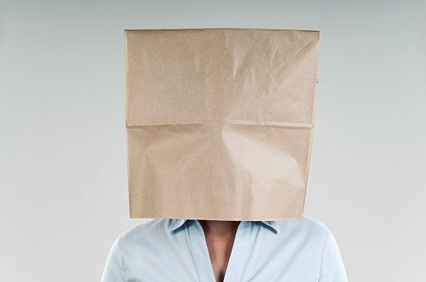 paper bag woman wearing a paper bag embarrassment unrecognizable person wearing a paper bag human head stock pictures, royalty-free photos & images