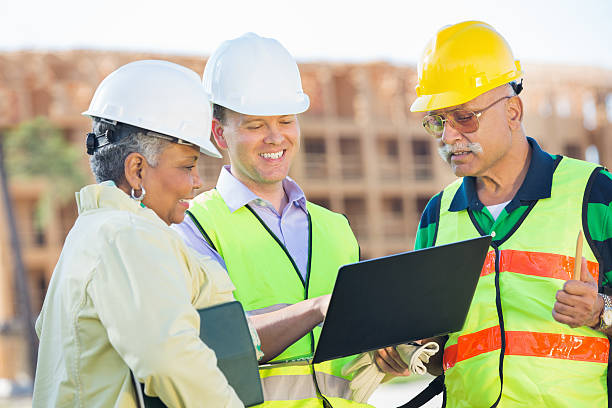 istock Building team working together on laptop at construction site 483784387