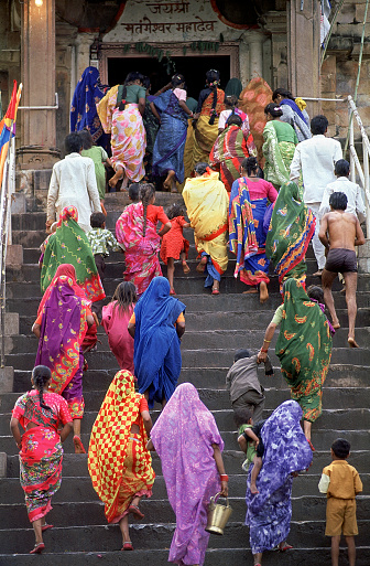 The Festival of Shivaratri - Indian worshippers in colourful saris run up steps and enter the Matangeshwar hindu temple in Khajuraho, Madhya Pradesh, India