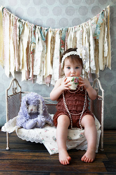 istock Little Girl Drinking Tea with Stuffed Bunny 483785629