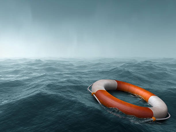 Lost at sea Lifebuoy floating in the vast expanse of sea lost stock pictures, royalty-free photos & images