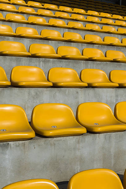 istock Field of empty yellow plastic stadium seats 483787134