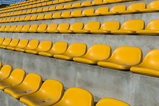 istock Field of empty yellow plastic stadium seats 483787186