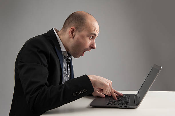 istock surprised businessman looking at his laptop 483787515