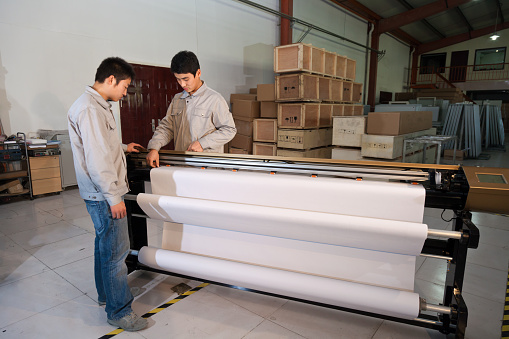 A cardboard sheets in stack. Perforated sheets of corrugated cardboard are stacked on pallets. Packaging of finished products in industrial production.