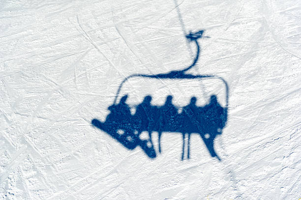 Vail, United States - January 10, 2015: the Vail ski gondola is photographed transporting skiers up the mountain for a day of powder skiing.  Pictured in black and white, it congers up images of the ski resort when it was founded in 1962.