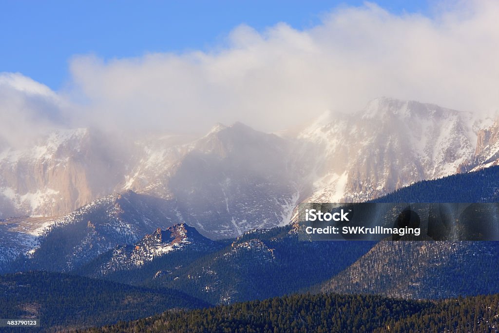 Stormy Peak Storm clouds roll in over the north face of Pikes Peak on a windy Colorado spring morning. Awe Stock Photo