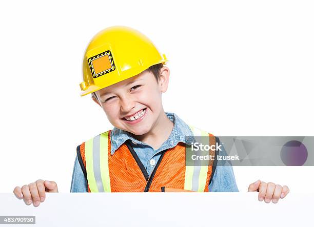 Happy Junior Construction Worker Holding Whiteboard Stock Photo - Download Image Now