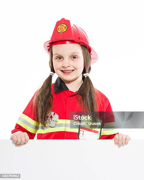Happy Firefighter Girl Holding Whiteboard Stock Photo - Download Image Now - Firefighter's Helmet, Girls, 2015