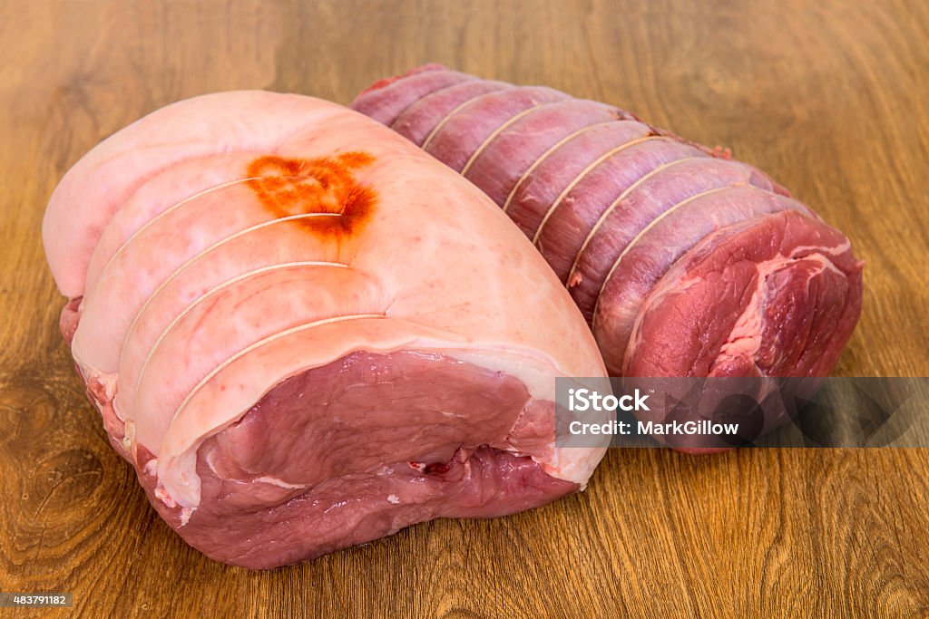 Rolled Pork leg with Brisket of beef joint Pork Leg and Brisket of beef joint on a wood background. Pork Stock Photo