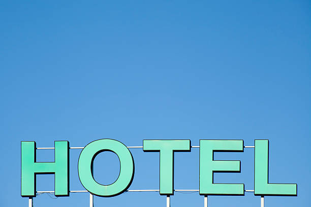 istock Hotel sign in the sunlight and blue sky above. 483793922