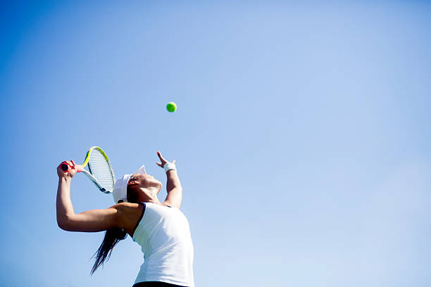 Beautiful female tennis player serving Beautiful female tennis player serving outdoor taking a shot sport photos stock pictures, royalty-free photos & images