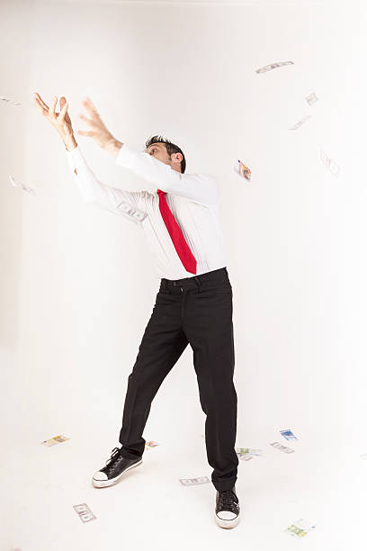 istock rain of banknotes on a young manager 483794514