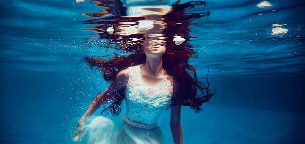 istock Girl swimming underwater 483794972